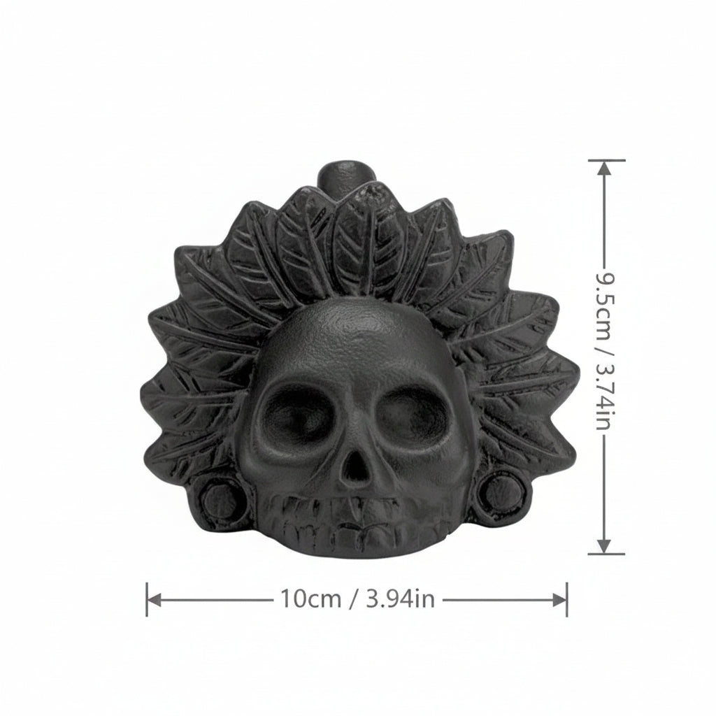 Black skull-shaped decorative item with leaf details and measurements on a white background